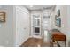 Hallway view with modern lighting, wooden floors, and a bathroom leading to a bedroom at 3040 S Dexter Way, Denver, CO 80222