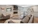 Bright living room with fireplace, mounted TV, and access to outdoor space at 3040 S Dexter Way, Denver, CO 80222