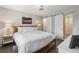 Bright main bedroom featuring ensuite bath with white double doors, natural light, and clean aesthetic at 3040 S Dexter Way, Denver, CO 80222