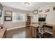 Office space with natural light, wood floors, and a built-in bookcase at 3040 S Dexter Way, Denver, CO 80222