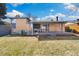 Large backyard featuring a well-maintained lawn, storage shed, and covered patio at 10699 W 9Th Pl, Lakewood, CO 80215