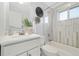 Modern bathroom features updated vanity, tiling, and tub-shower combination at 10699 W 9Th Pl, Lakewood, CO 80215