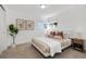 Bedroom with modern decor features neutral tones and natural light from windows at 10699 W 9Th Pl, Lakewood, CO 80215