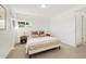 Bedroom with modern decor features neutral tones and natural light from windows at 10699 W 9Th Pl, Lakewood, CO 80215