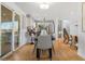 Open dining room with a kitchen view, hardwood floors, and sliding glass doors to outdoor space at 10699 W 9Th Pl, Lakewood, CO 80215