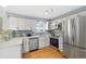 Modern kitchen with stainless steel appliances, quartz countertops, and soft gray backsplash at 10699 W 9Th Pl, Lakewood, CO 80215