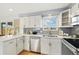 Updated kitchen featuring quartz countertops, stainless steel appliances, and stylish cabinets at 10699 W 9Th Pl, Lakewood, CO 80215