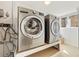 Convenient laundry room equipped with a full size washer, dryer, and window at 10699 W 9Th Pl, Lakewood, CO 80215