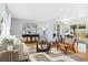 Bright living room featuring hardwood floors, modern decor, and an open layout with a dining area at 10699 W 9Th Pl, Lakewood, CO 80215