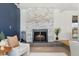 Comfortable living room featuring a modern fireplace and calming blue accent wall at 10699 W 9Th Pl, Lakewood, CO 80215