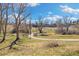 An image showing the landscaping, trees, and walking paths of Sunset Park on a sunny day at 10699 W 9Th Pl, Lakewood, CO 80215