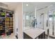 Bathroom with closet storage and glass shower at 2640 S Orchard St, Lakewood, CO 80228