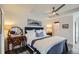 Inviting bedroom with tray ceiling, ceiling fan, and an elegant vintage writing desk at 2640 S Orchard St, Lakewood, CO 80228
