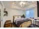 Cozy bedroom with natural light, modern lighting, and a view of the outside at 2640 S Orchard St, Lakewood, CO 80228