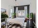 Stylish bedroom with unique light fixture, natural light, and minimalist decor at 2640 S Orchard St, Lakewood, CO 80228