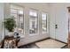 Bright entryway with hardwood floors, a potted plant, and a view to the exterior at 2640 S Orchard St, Lakewood, CO 80228