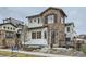 Charming two-story home with stone accents, landscaped yard, and inviting front porch seating area at 2640 S Orchard St, Lakewood, CO 80228