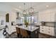 Elegant kitchen featuring a center island, stainless-steel appliances, and stylish pendant lights at 2640 S Orchard St, Lakewood, CO 80228