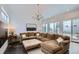 Spacious living room featuring a large sectional sofa, elegant lighting, and access to an outdoor patio at 2640 S Orchard St, Lakewood, CO 80228