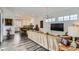 Bright and airy living room open to the kitchen, featuring hardwood floors and modern lighting fixtures at 2640 S Orchard St, Lakewood, CO 80228