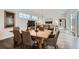 Open-concept living space with a large dining table and an adjoining living room with lots of windows at 2640 S Orchard St, Lakewood, CO 80228