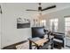 Home office with natural light, modern ceiling fan, and view of a private outdoor space at 2640 S Orchard St, Lakewood, CO 80228