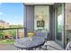 Cozy balcony with a bistro table, city views, and indoor/outdoor living access at 155 Steele St # 414, Denver, CO 80206