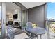 Relaxing balcony with outdoor seating with inside living area, seamlessly blending comfort and style at 155 Steele St # 414, Denver, CO 80206