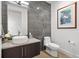 Stylish powder room with vessel sink, modern faucet, artistic wall art, and toilet at 155 Steele St # 414, Denver, CO 80206