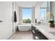 Bright bathroom features a freestanding tub, modern fixtures, and light tile floors at 155 Steele St # 414, Denver, CO 80206