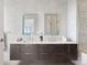 Bright bathroom features dual sinks, modern fixtures, white tile walls, and a dark wood vanity at 155 Steele St # 414, Denver, CO 80206