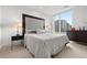 Comfortable bedroom with a large window, plush bedding, and a modern design at 155 Steele St # 414, Denver, CO 80206