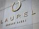 Close-up of the building sign for Laurel Cherry Creek at 155 Steele St # 414, Denver, CO 80206