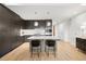 Modern kitchen with sleek cabinetry, center island with bar stools, and stainless steel appliances at 155 Steele St # 414, Denver, CO 80206