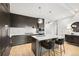 Stylish kitchen boasts a central island, wooden floors, stainless steel appliances, and custom cabinetry at 155 Steele St # 414, Denver, CO 80206