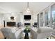 Elegant living room featuring modern fireplace and access to a spacious balcony at 155 Steele St # 414, Denver, CO 80206