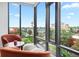 Relaxing nook with cityscape view from expansive windows and cozy decor at 155 Steele St # 414, Denver, CO 80206
