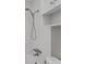 Close up on tiled bath and shower featuring a shower head, faucet and handles at 336 N Grant St # 408, Denver, CO 80203