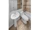 Clean bathroom with a pedestal sink, toilet, and bathtub at 2685 S Dayton Way # 74, Denver, CO 80231