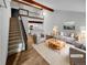 Virtually staged living room with hardwood floors, a loft, and kitchen views at 2685 S Dayton Way # 74, Denver, CO 80231