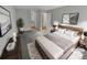 Virtually staged main bedroom with a plush bed and en-suite bathroom access at 2685 S Dayton Way # 74, Denver, CO 80231