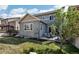 Backyard showcasing a patio area with outdoor seating and lush greenery, ideal for outdoor living at 12233 Hannibal St, Commerce City, CO 80603