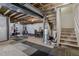 Partially finished basement area featuring exposed ductwork, a small gym, and a carpet tile floor at 12233 Hannibal St, Commerce City, CO 80603