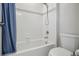 Bright bathroom featuring white tile, a shower-tub combination, and modern fixtures at 12233 Hannibal St, Commerce City, CO 80603