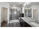 Modern bathroom featuring a glass-enclosed shower, dual sinks, and sleek, contemporary finishes at 12233 Hannibal St, Commerce City, CO 80603