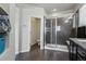 Bright bathroom with a spacious glass shower, dark wood floors, and a convenient toilet room at 12233 Hannibal St, Commerce City, CO 80603