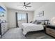 Serene bedroom with a cozy bed, ceiling fan, window and soothing gray tones at 12233 Hannibal St, Commerce City, CO 80603