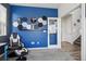Bedroom with colorful accent wall, gaming chair and stool, and french doors at 12233 Hannibal St, Commerce City, CO 80603