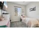 Cozy bedroom featuring a window with blinds, comfortable bed, and decor at 12233 Hannibal St, Commerce City, CO 80603