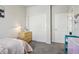 Neutral bedroom with a closet, open door, and a cozy space for relaxation at 12233 Hannibal St, Commerce City, CO 80603